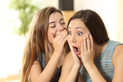 Two young women sharing gossip