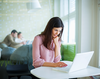 Woman grinning at her computer