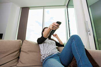 holding a tv remote in order to change channel